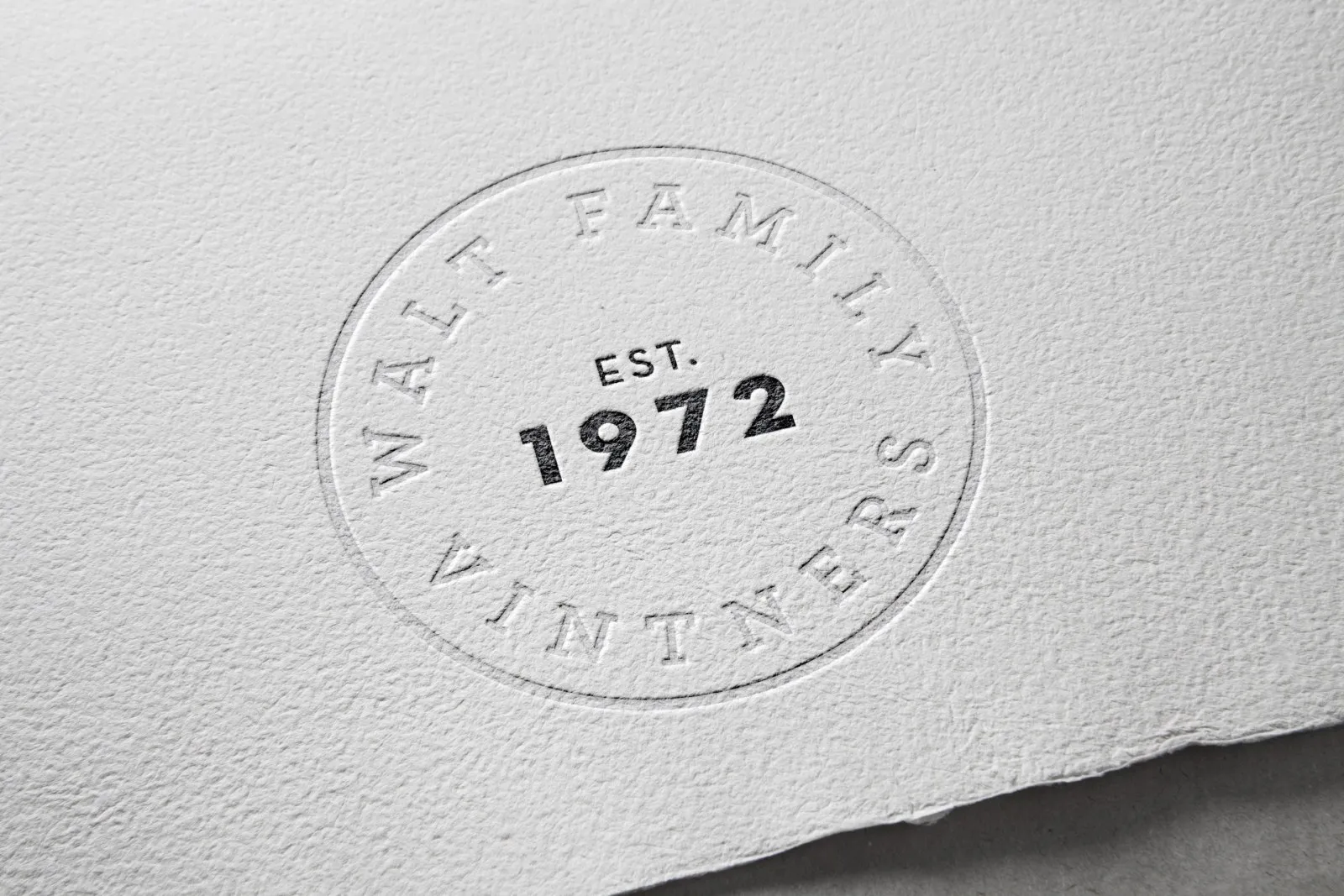 The EST. 1972 seal blind embossed on textured paper