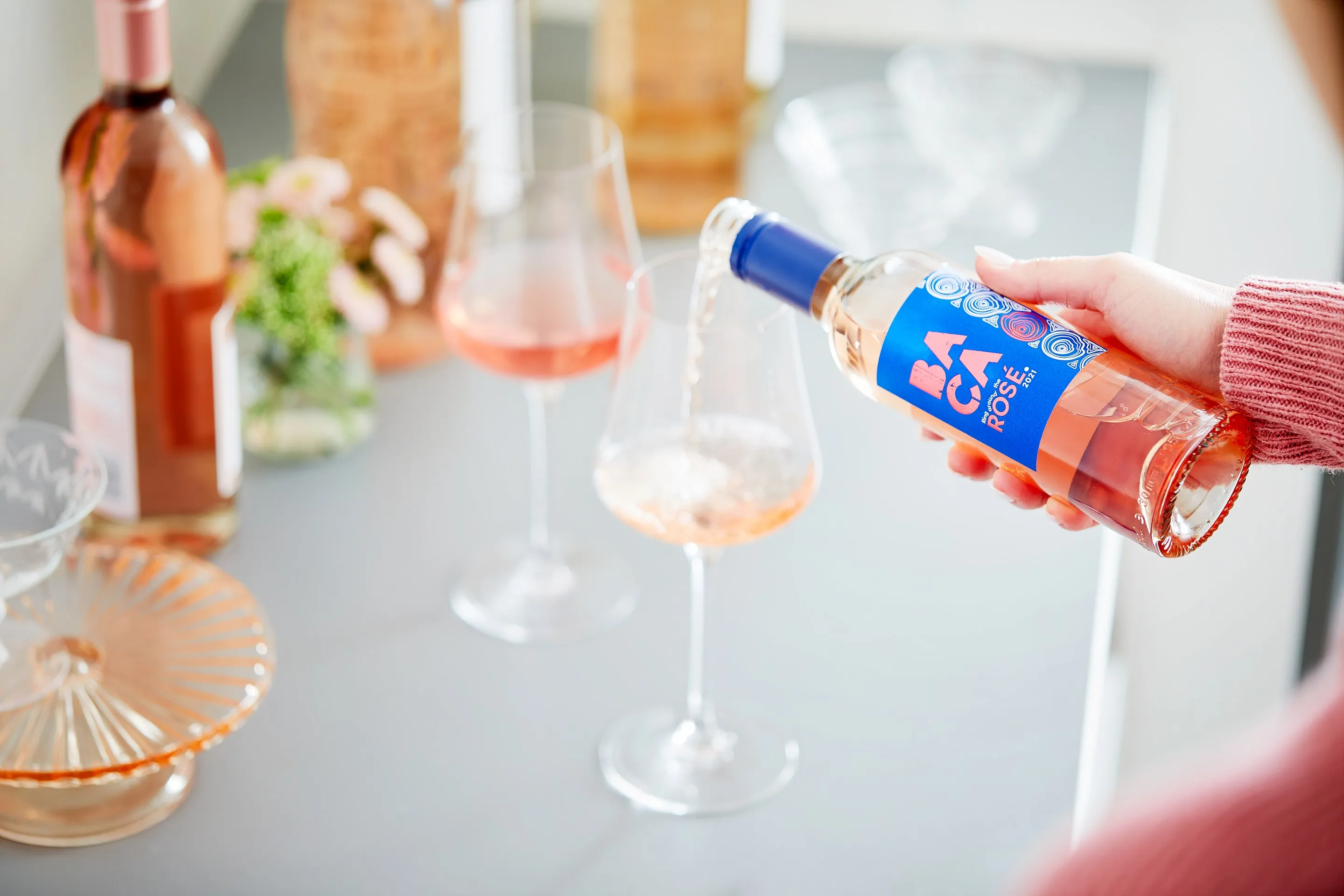 A half bottle of BACA Rosé being poured into glasses