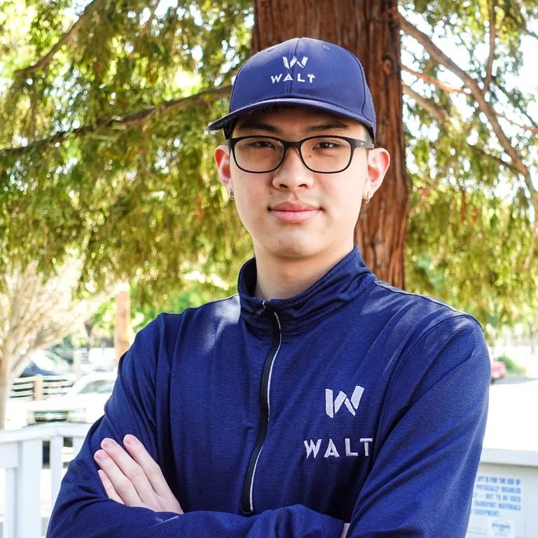 A WALT team member in a WALT cap and quarter zip